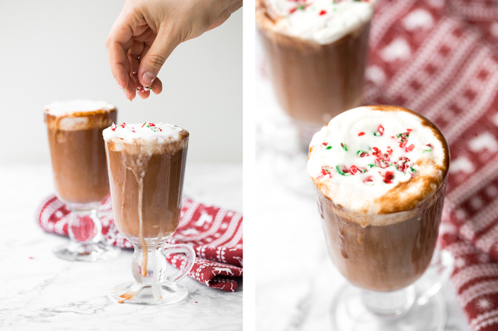 easy hot chocolate woman sprinkling two glasses filled with cocoa with colorful pops