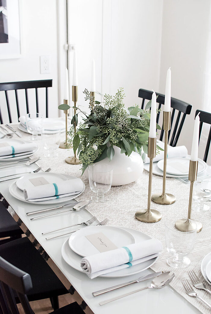 elegant thanksgiving in white and metal tall candle sticks white porcelain and green centerpiece