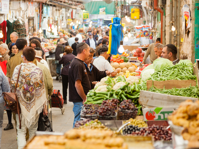 Machane Yehuda large food market with many people shopping for food