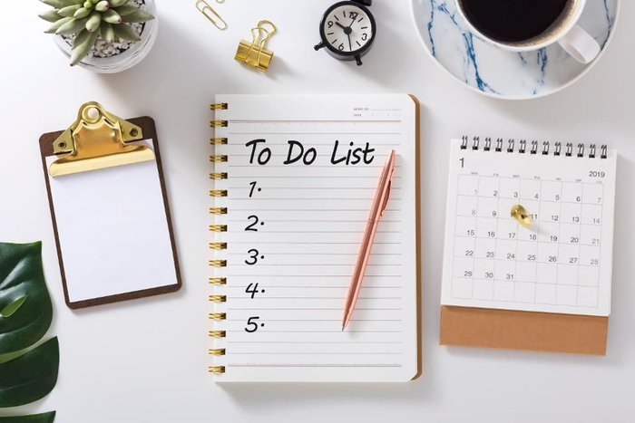 build good habits calendar to do list a cup of coffee and living plants on a white desk