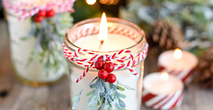 pretty holiday candles with red and white christmas decorations