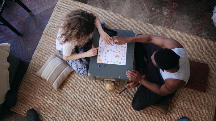 couple sitting on the floor playing board games