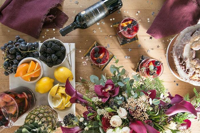 beautiful table shot from above with flowers fruits wine and glitters spread around