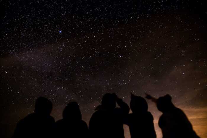 alternative ways to celebrate the new year friends at night stargazing