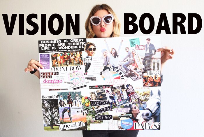 woman in sunglasses and red lipstick holding a colorful vision board