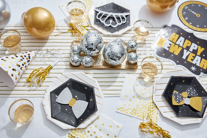 festive table close up snap with props and disco balls on a white table cloth
