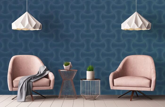 classic blue interior wall with two pink chairs and metal wire tables under two paper fold lamps