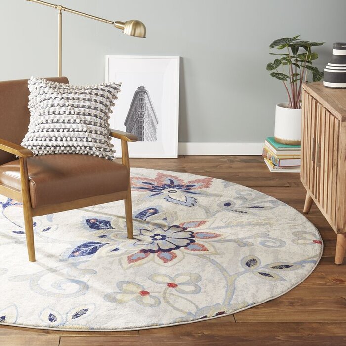 floral accent carpet in a home office with wooden furniture in brown and metal lamp