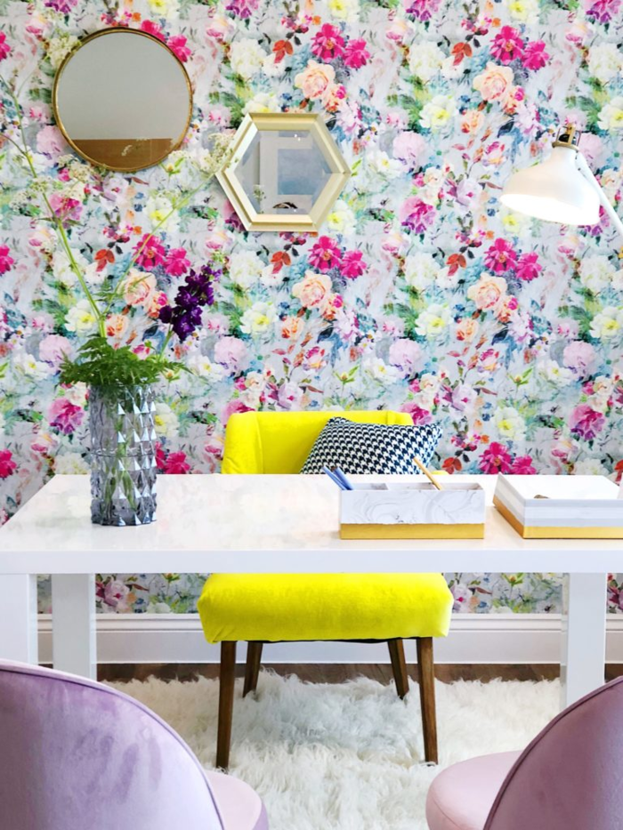 floral office space with bright colors on the wall simple white table and a bright yellow chair 