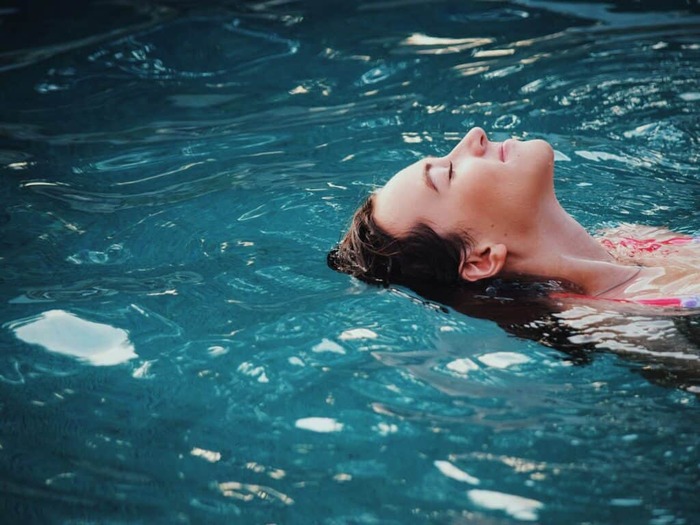 quiet your mind with peaceful swimming woman close up swimming in water