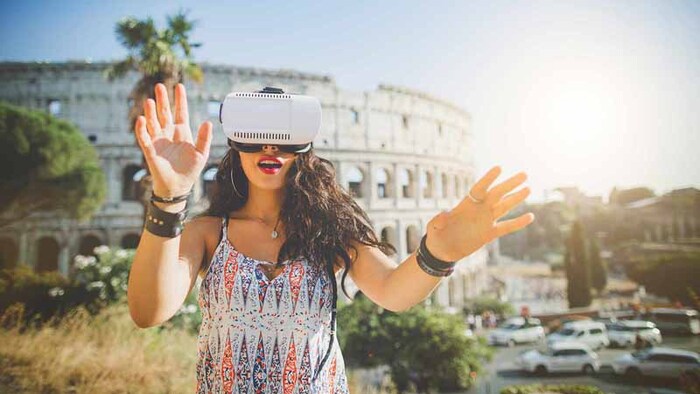 vr tourism woman in a colorful summer dress with a virtual reality headset outdoors in Rome