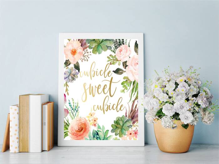 floral accents in the office colorful print with a message books and a golden pot with a bouquet