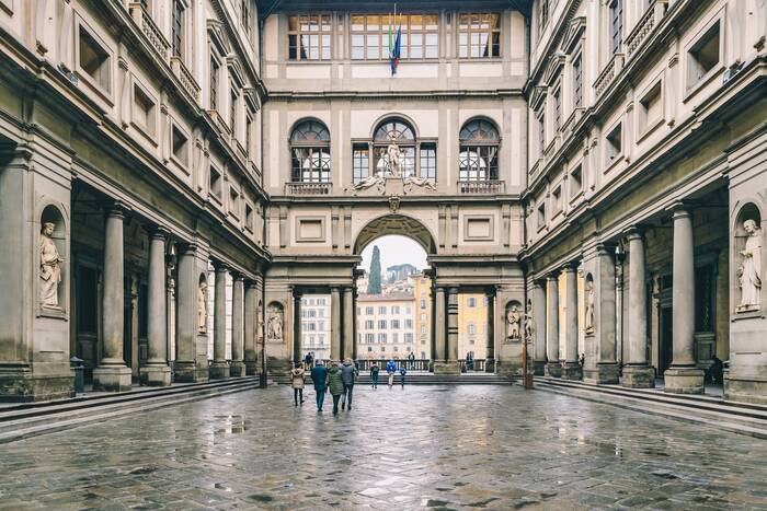 Uffizi Museum and Gallery in a rainy day people walking towards the buildings