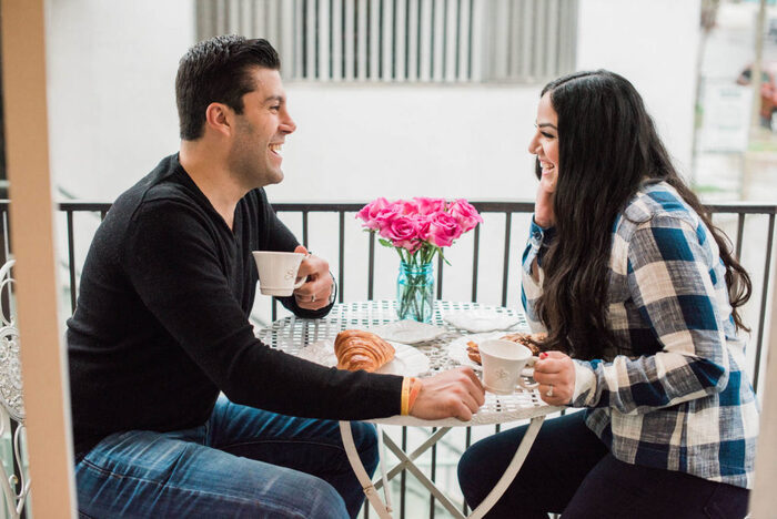 date at home a couple dining on the balcony romantic breakfast sharing a laugh