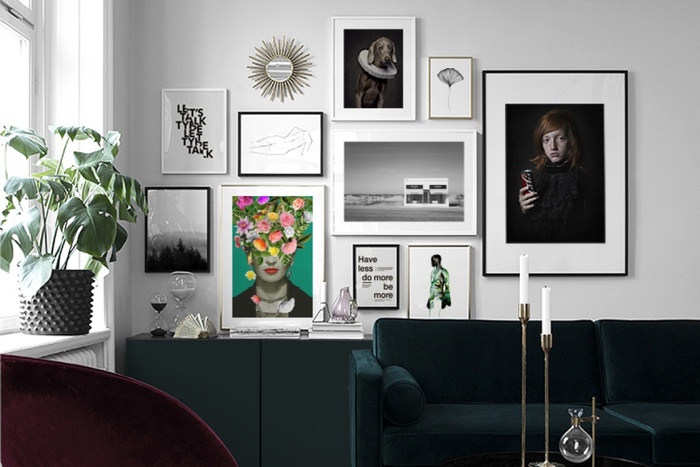 gallery wall sleek interior in contrasting colors with art in different frames on a grey wall