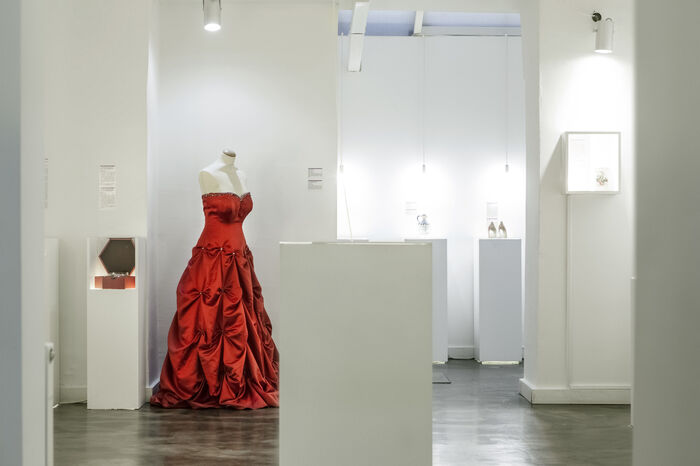 museum of broken relationships in croatia white interior and a red dress