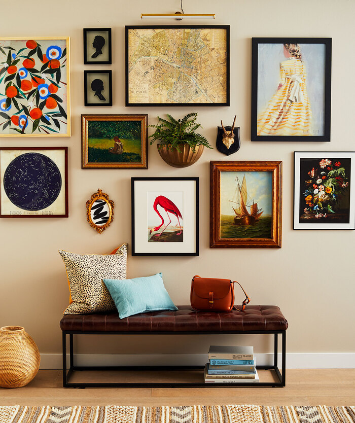 salon style wall with different art and paintings with colorful accents