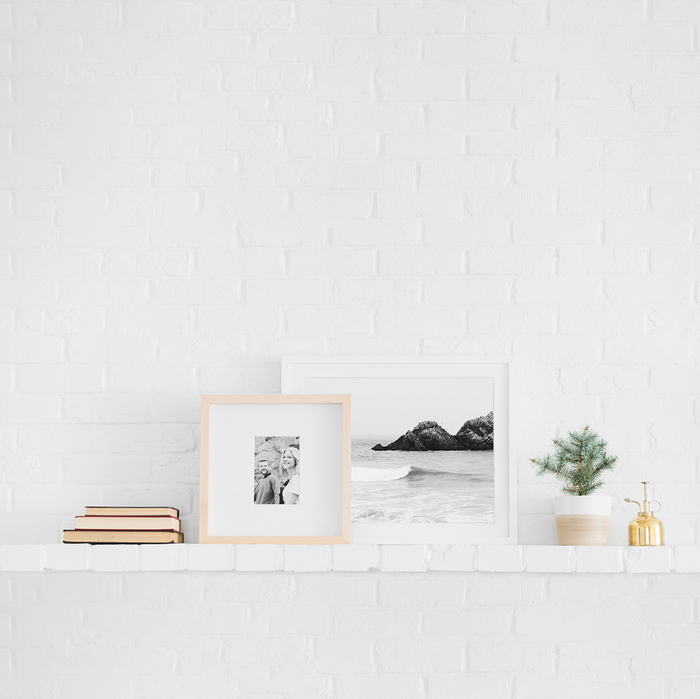 elegant art on a contrasting white brick wall on a white shelf