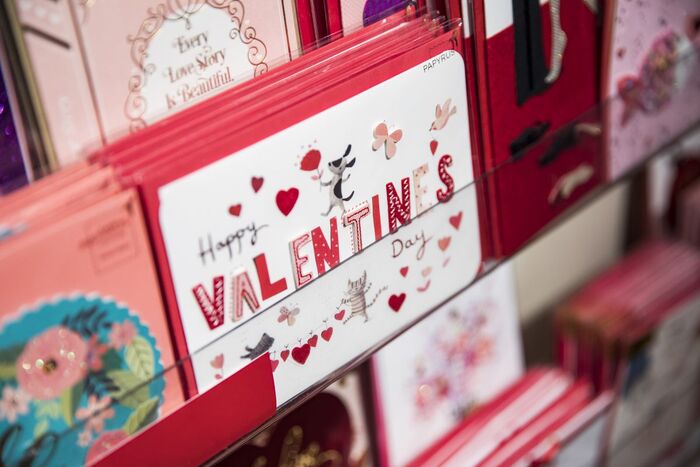 valentine's day post cards in a shop arranged in red and pink color block