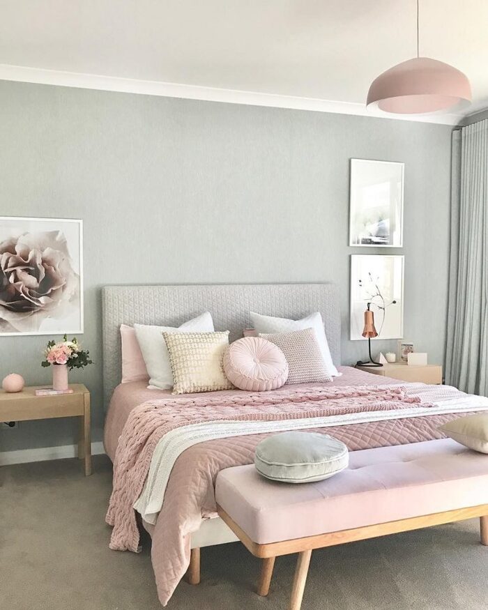 pastel decor bedroom light blue walls pink bed with decorative cushions and pink accents