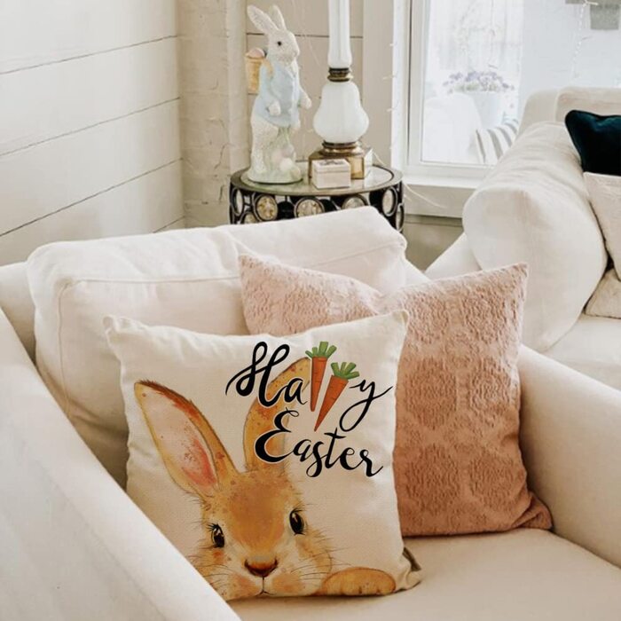 bunny pillow with easter motif on a white sofa in a light living room interior