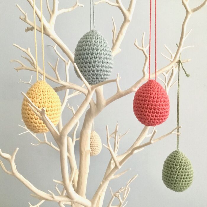hanging egg centerpiece decoration white branches with hanging knitted eggs on it