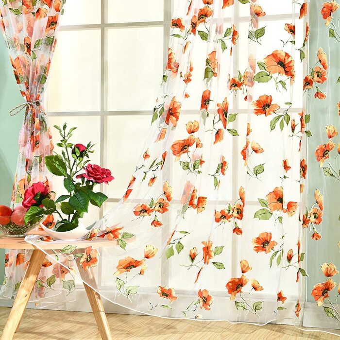 spring curtains with red flowers and a small table with red roses on it