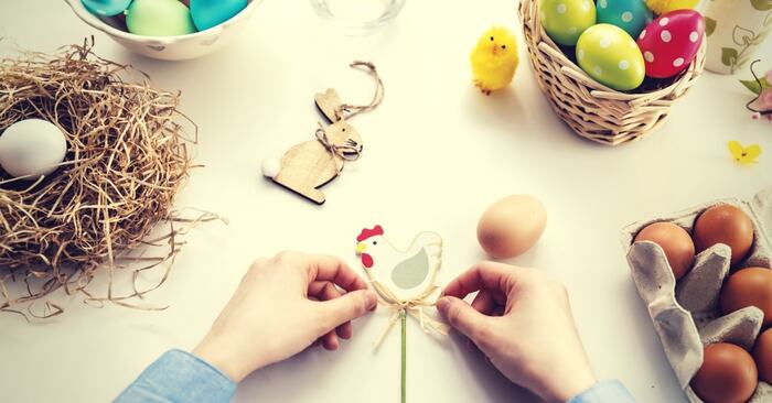 unusual traditions easter crafts hands on a white table crafting and making diy chicken and rabbits and painted eggs