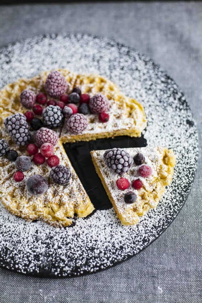 vegan sweets brunch waffles sprinkled with powder sugar and forest fruits 