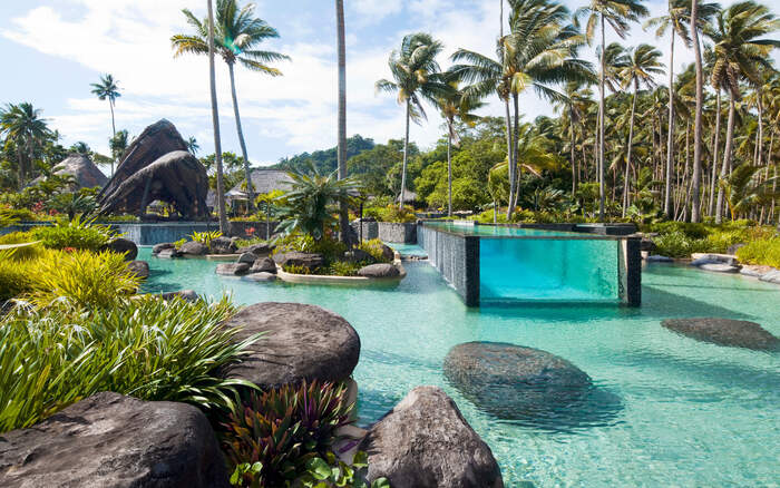 Fiji villa with stunning pool and tall palm trees