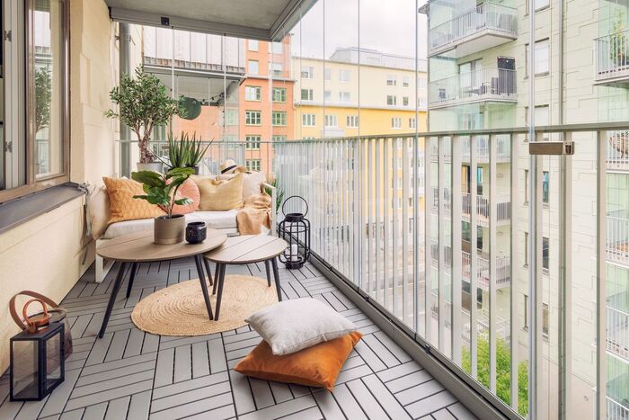 balcony design urban balcony with a gray wooden floor living plants and cushions on the floor