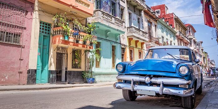 sight in cuba colorful houses and a classic retro car on the street
