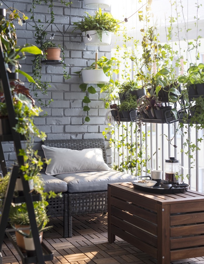 front balcony with rattan furniture hanging lights and green plants