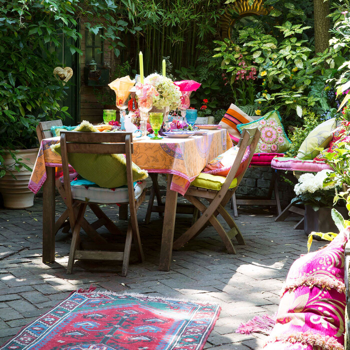 outdoor party colorful outdoor space with wooden furniture in a secret small garden with green plants 