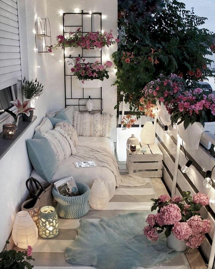 romantic balcony in neutral soft colors with ambient lights lanterns and blooming flowers