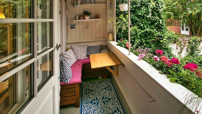 small balcony ideas white urban balcony with wooden corner bench and blooming plants