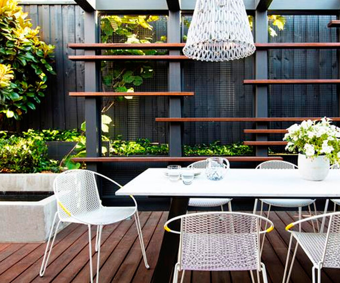 small urban garden with modern design in black and white with an outdoor lamp and green plants
