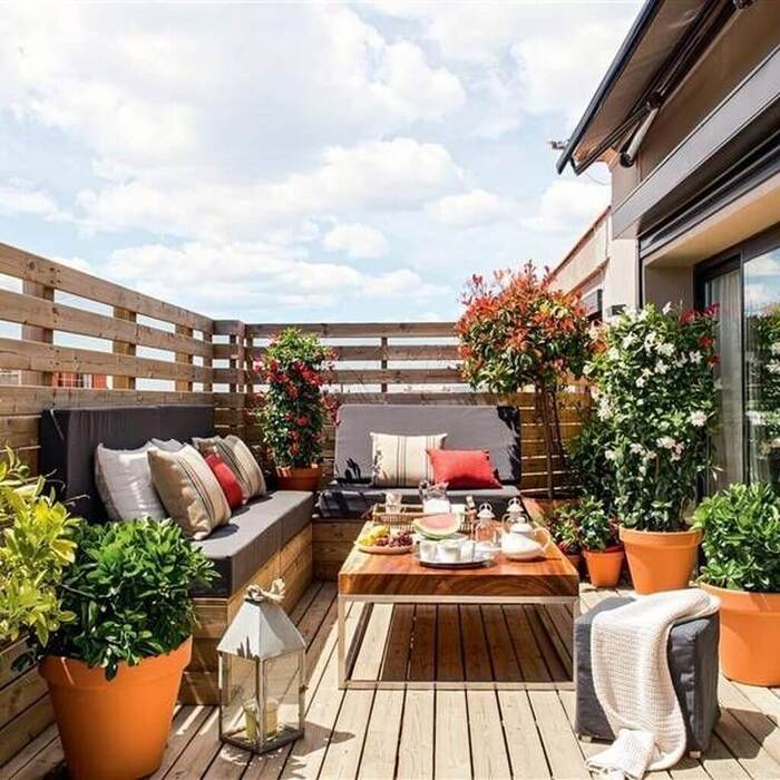 transform your balcony with a touch of provence modern city balcony with wooden floor and furniture and potted plants