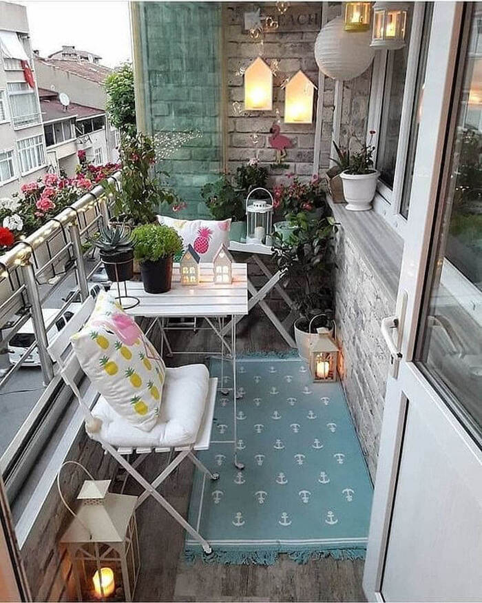 urban balcony with cute white furniture and romantic decorations and lanterns