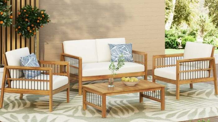 wooden garden furniture in light brown with white and blue cushions 