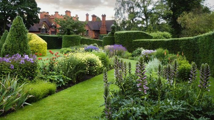 the art of English landscaping an aristocratic garden with sculpted bushes and flower borders