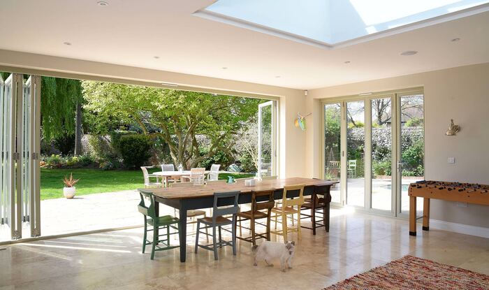 large dining area with surrounded by glass doors and a glass on the ceiling