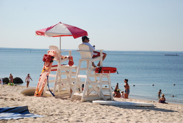 lifeguard on a sandyy beach guarding the beach and the water