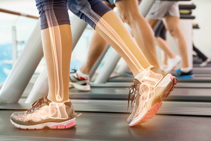 at the gym peoples legs on a treadmill with bones in neon color showing their bone structure