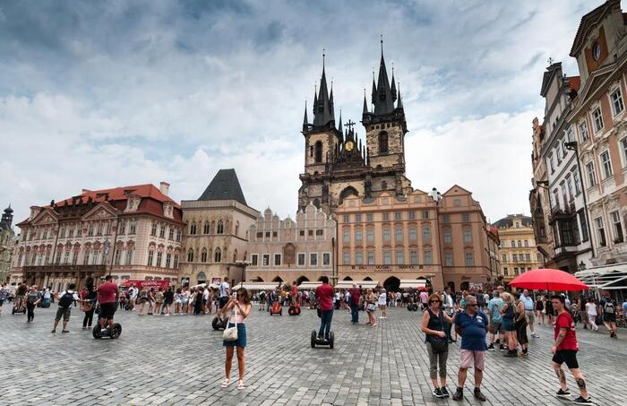 city tourism the main square in prague with people walking and taking pictures