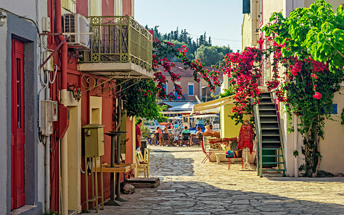 fiskardo town quiet street in kefalonia greece with terraces and flowers hanging from the walls