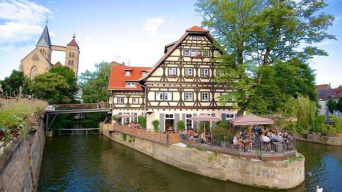 germany terrace on a piece of land in between two rivers and a typical german house in yellow