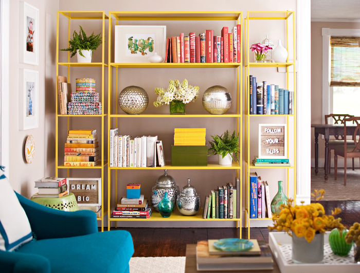 summer interior decor yellow shelves in a living space with books and other colorful accessories 