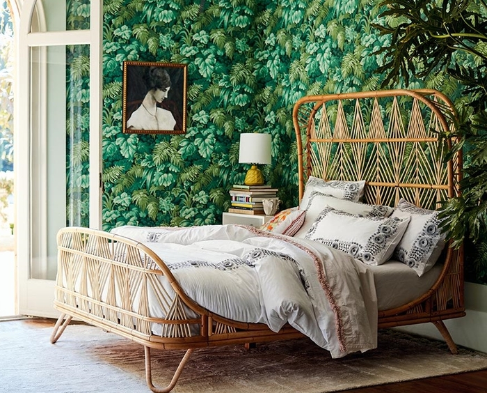 touch of rattan boho bedroom with green tropical wallpapers and a rattan bed 