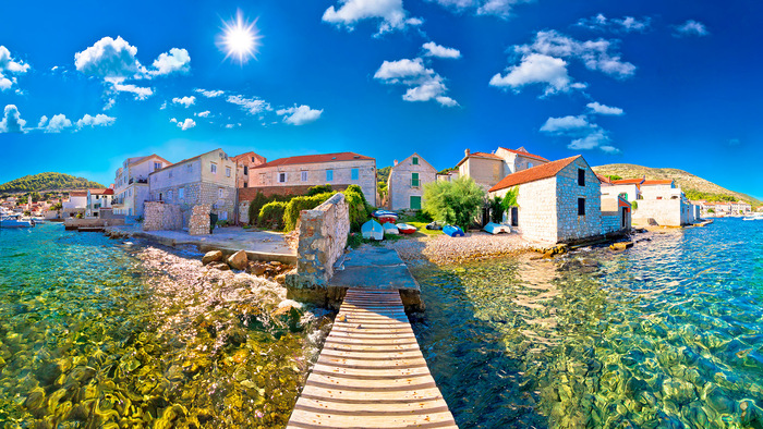 vis island croatia panoramic view clear water and stone buildings in the background